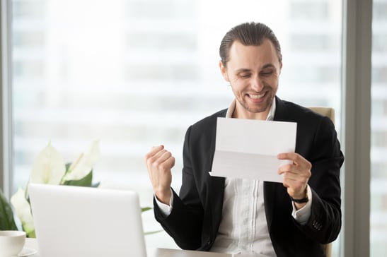 happy-businessman-celebrates-receiving-good-business-news